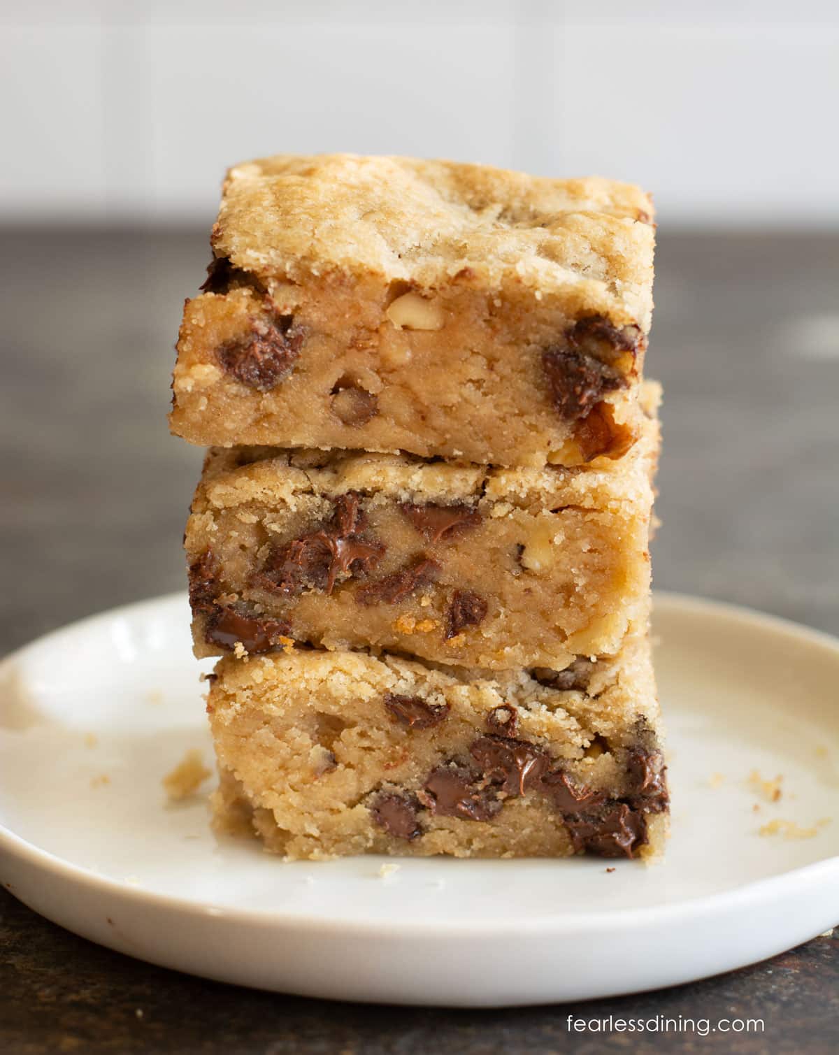 A stack of three gluten free maple pecan blondies.