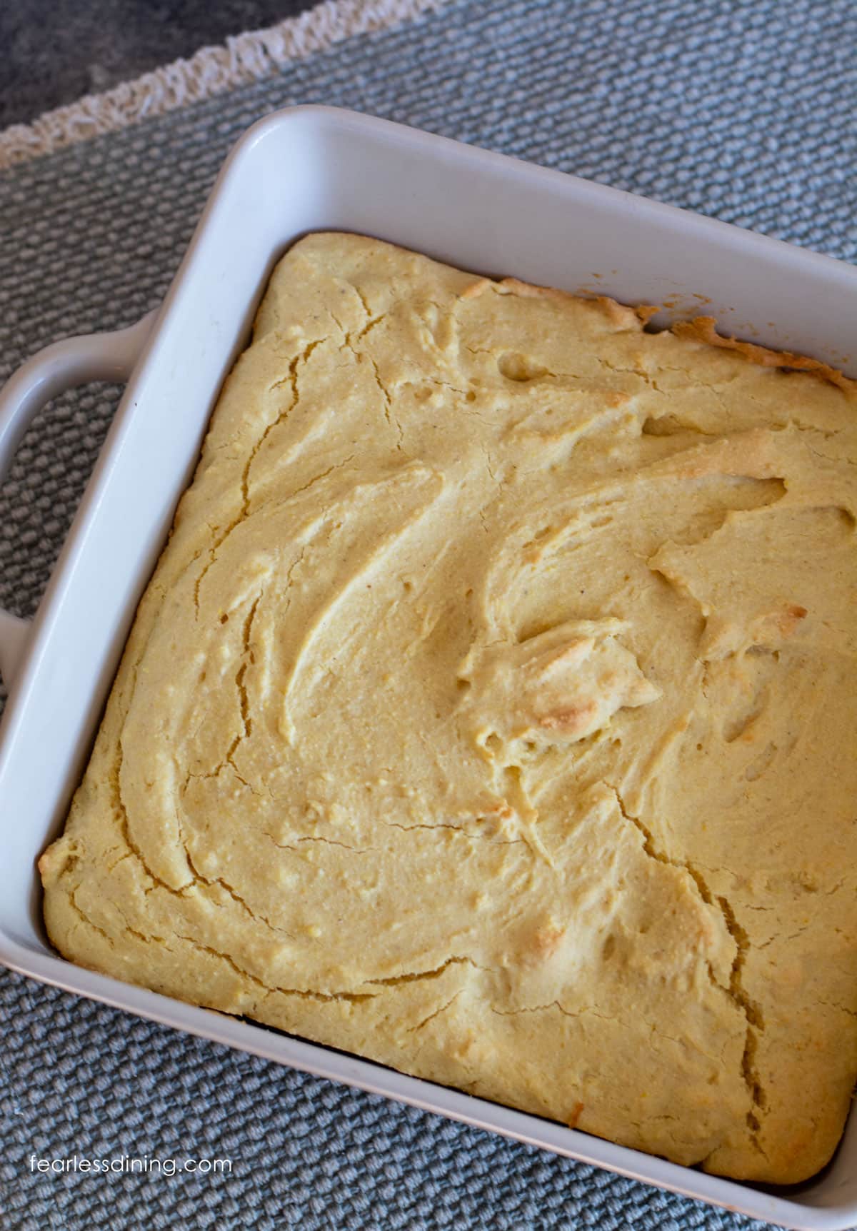 The baked gluten free cornbread in a white square 8x8 casserole dish.