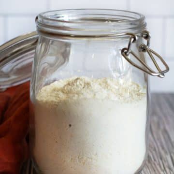 A mason jar filled with homemade cornbread mix on the counter.