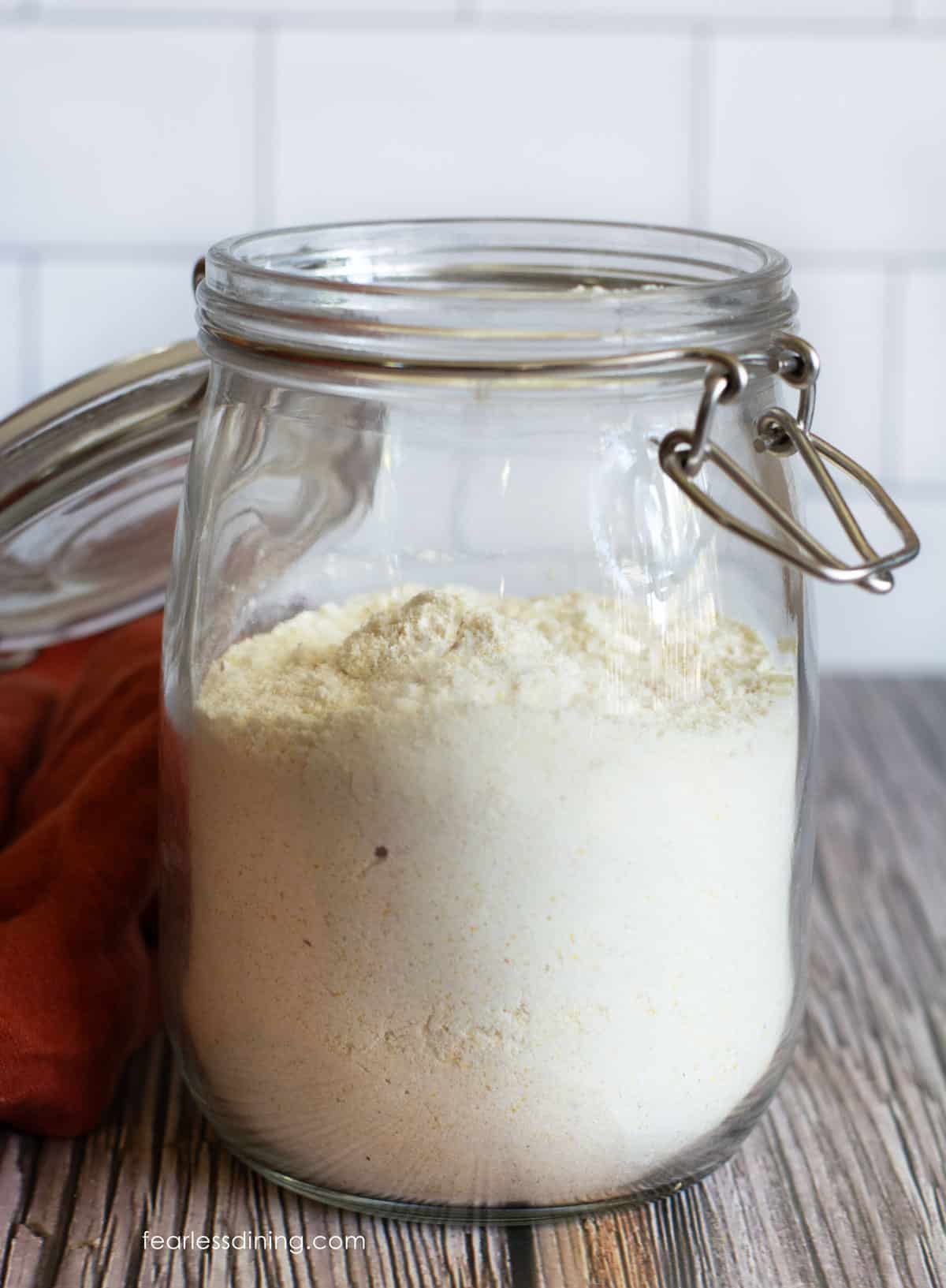 A mason jar filled with homemade cornbread mix on the counter.