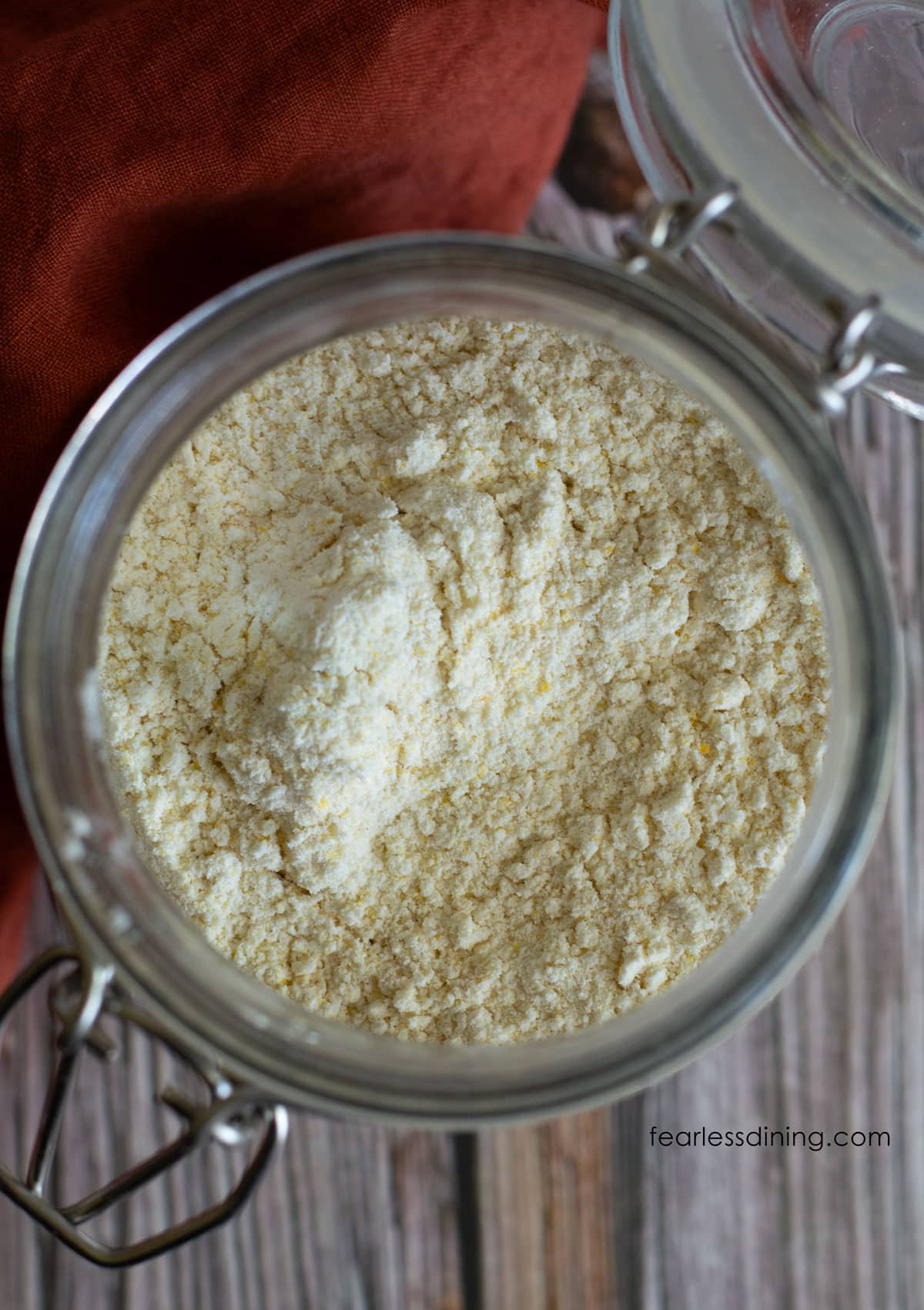 A close up shot of the cornbread mix in the open mouth of the jar.