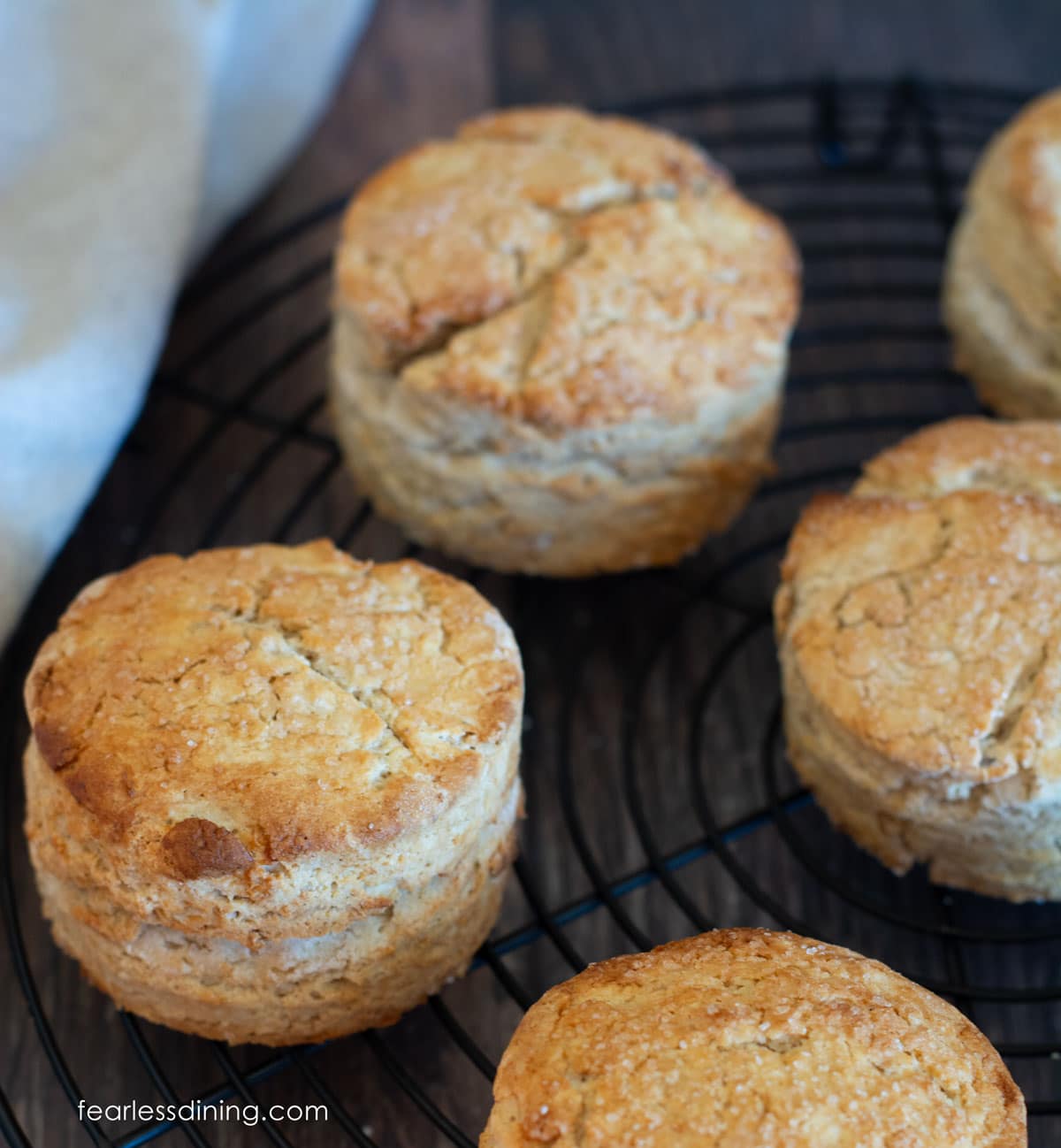 Five maple oat biscuits on a round cooling rack.