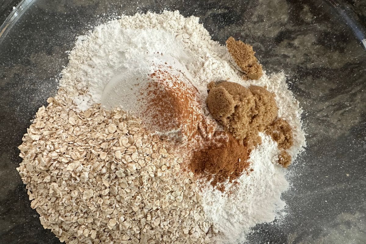 The dry ingredients in a large glass mixing bowl.