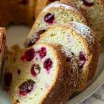 A close up picture of the sliced bundt cake so you can see the fresh cranberries inside.