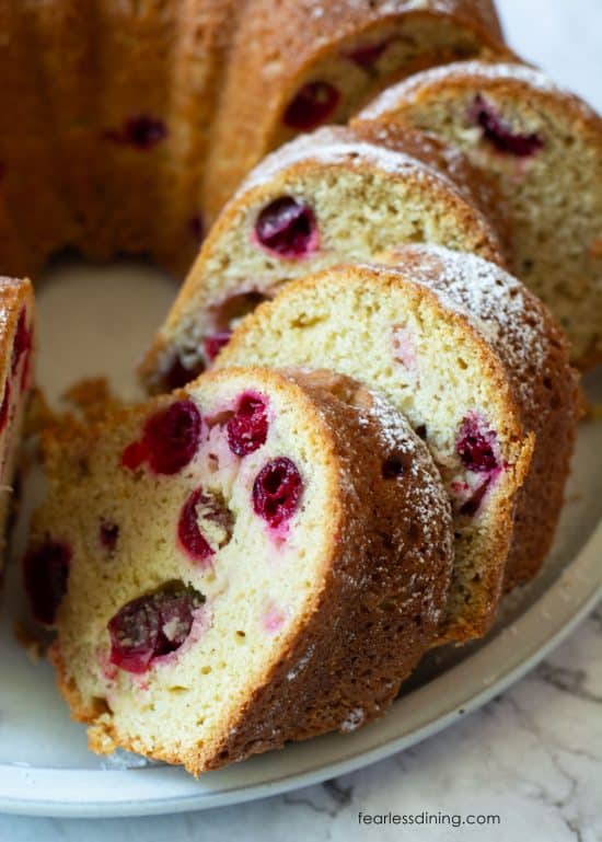 A close up picture of the sliced bundt cake so you can see the fresh cranberries inside.