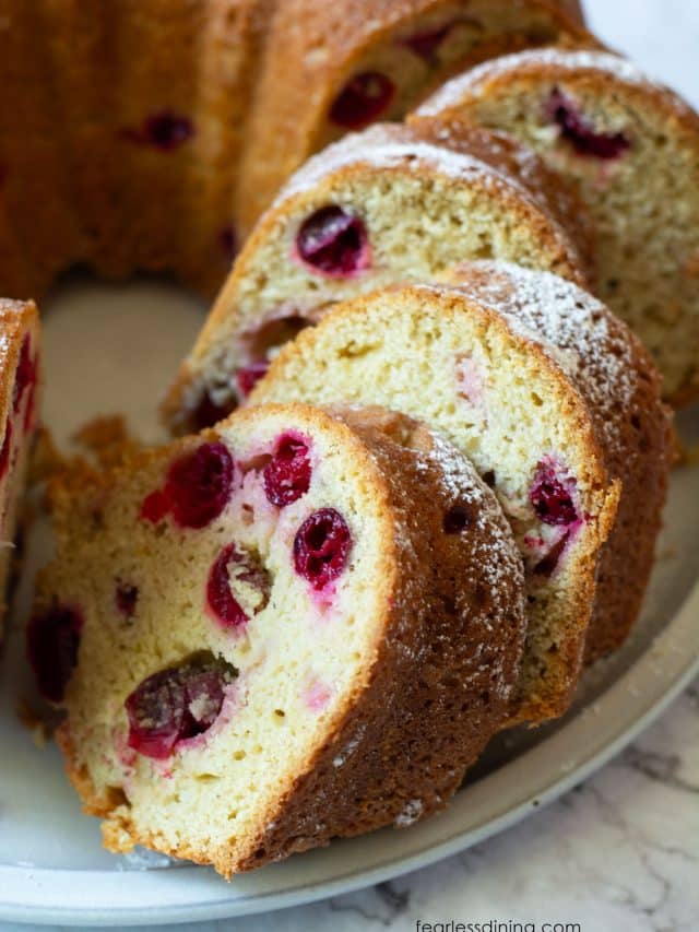 A close up picture of the sliced bundt cake so you can see the fresh cranberries inside.
