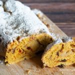 Sliced stollen on a wooden cutting board.