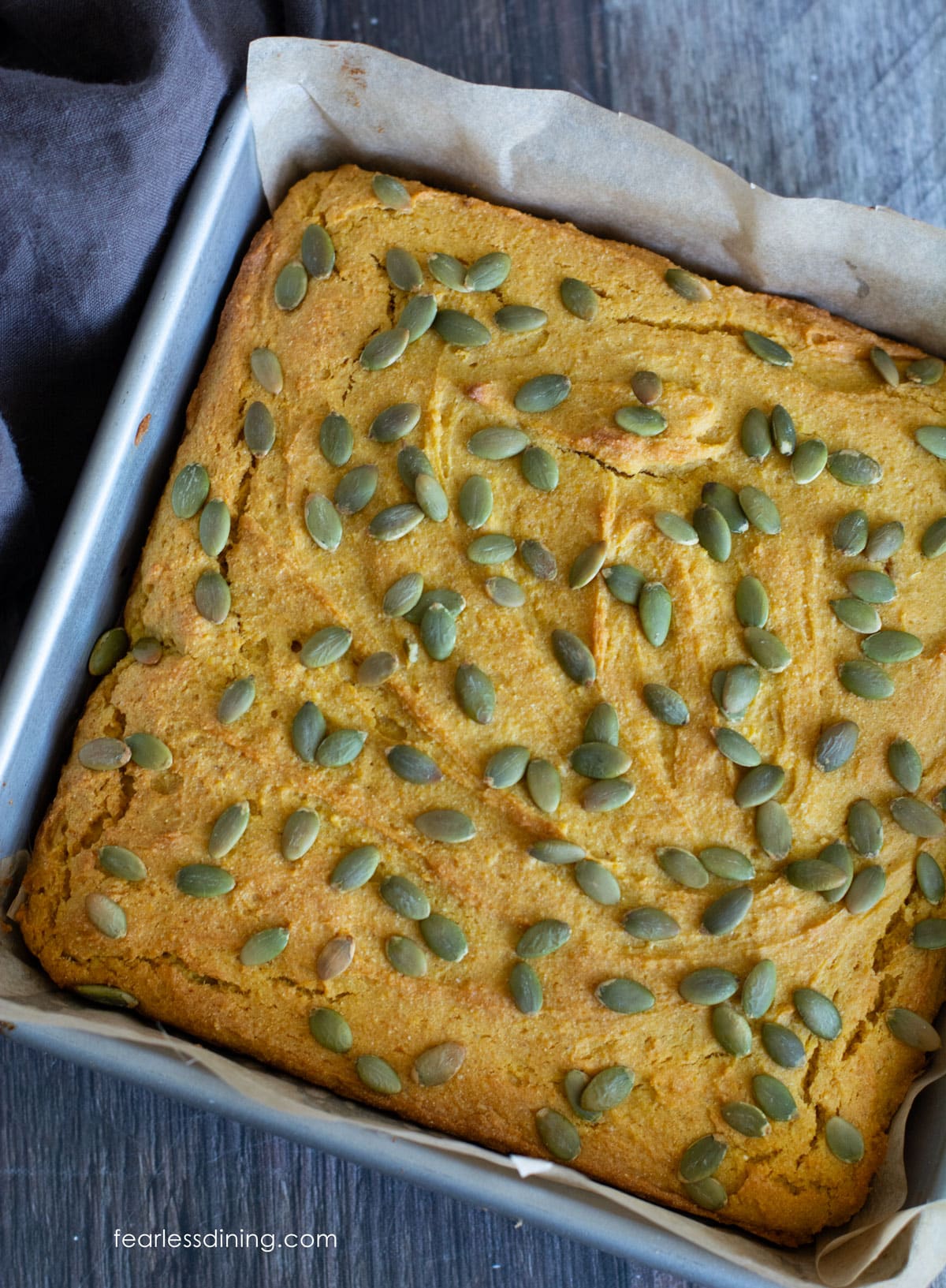 The baked pumpkin maple cornbread in a metal 8x8 pan.