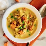 A bowl full of chicken and sweet potato curry.