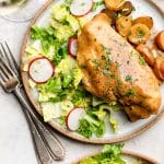 Two plates with the slow cooker mustard chicken with salad.