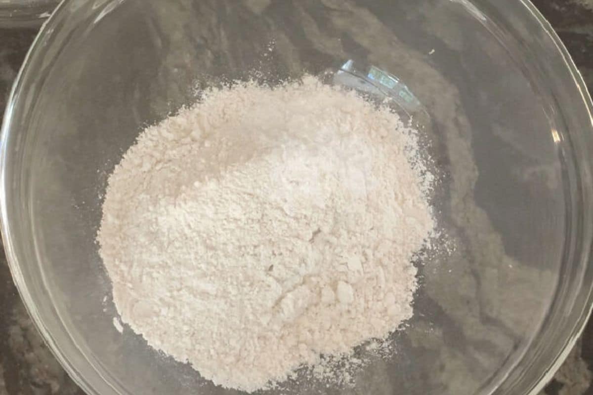 A large mixing bowl with the gluten free flour, baking powder, and salt.