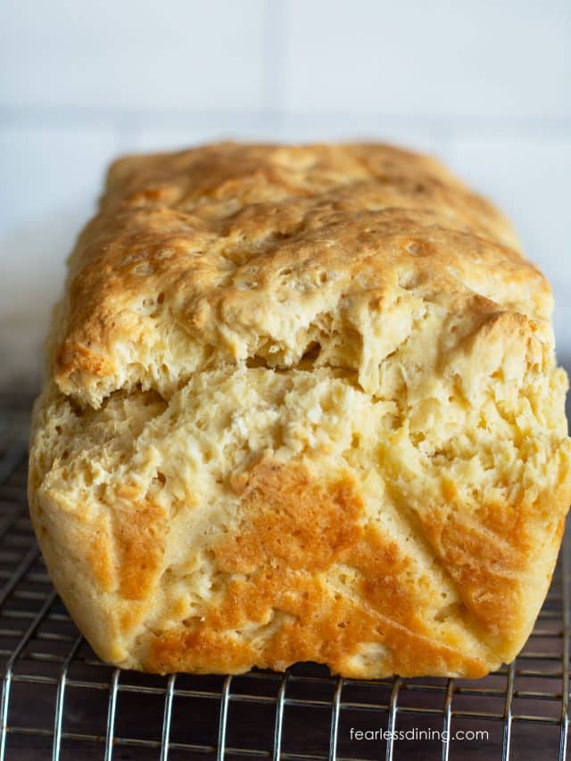 The front view of a baked loaf of gluten free no yeast bread on a wire rack.