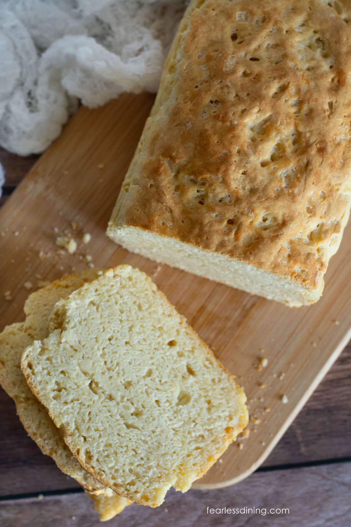 The top view of a sliced loaf of yeast free bread on a wooden cutting board.