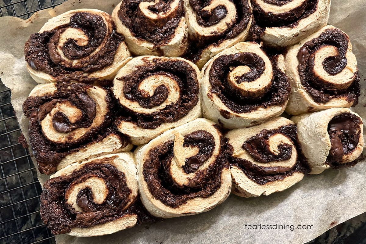 Baked Nutella rolls on a wire cooling rack.