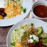 A slow cooker chicken burrito bowl garnished with sour cream.