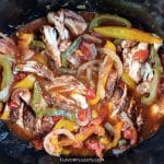 The cooked chicken fajita tacos in a slow cooker.