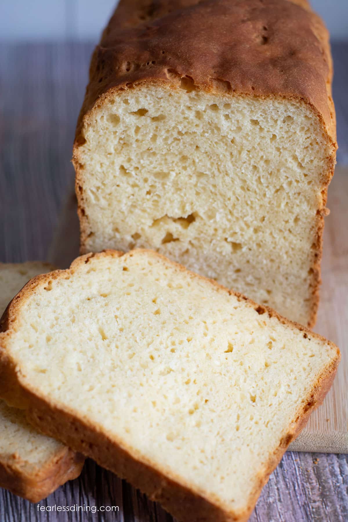 A photo of the bread tested with Cup4Cup flour blend. It is sliced on a cutting board.