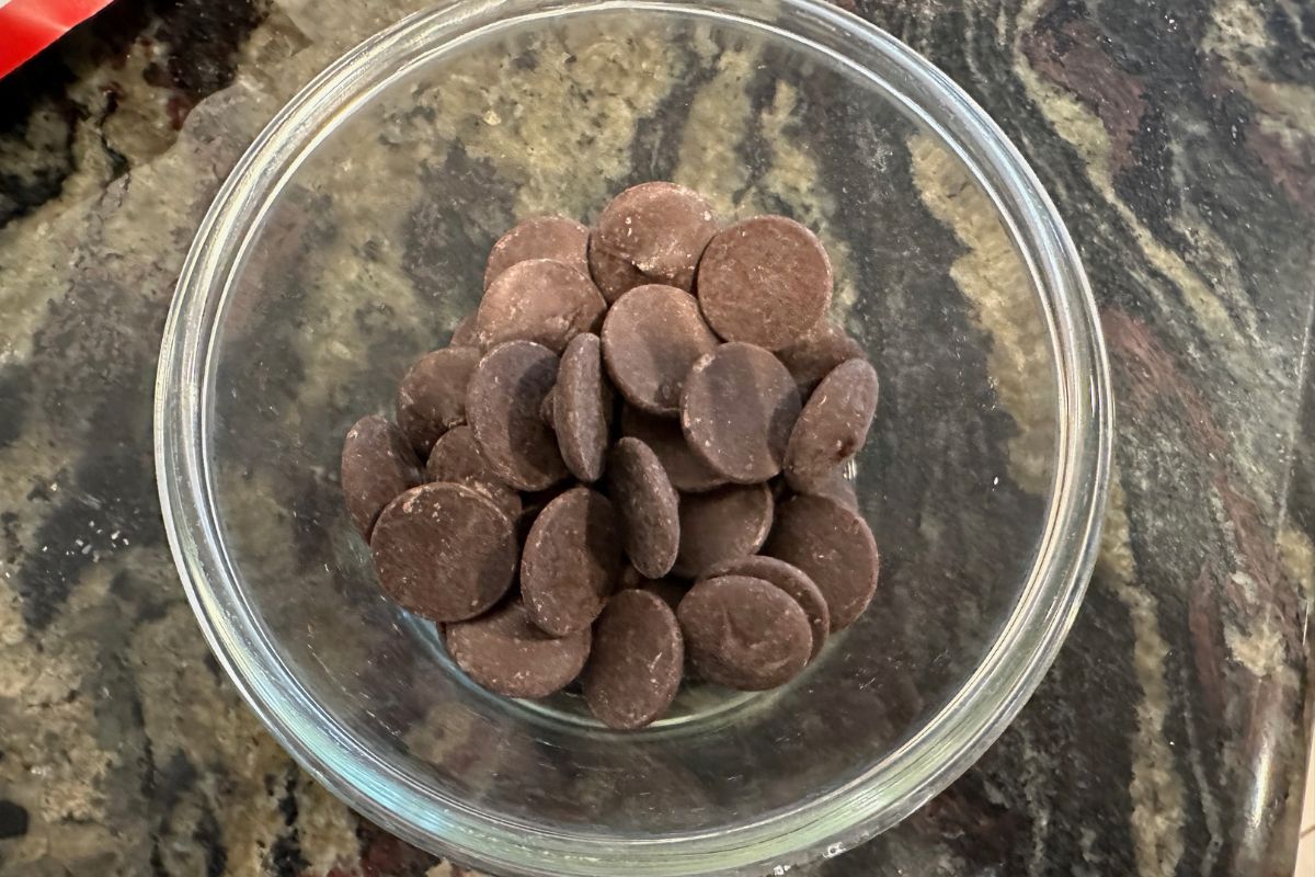 The melting chocolate wafers in a microwave-safe bowl.