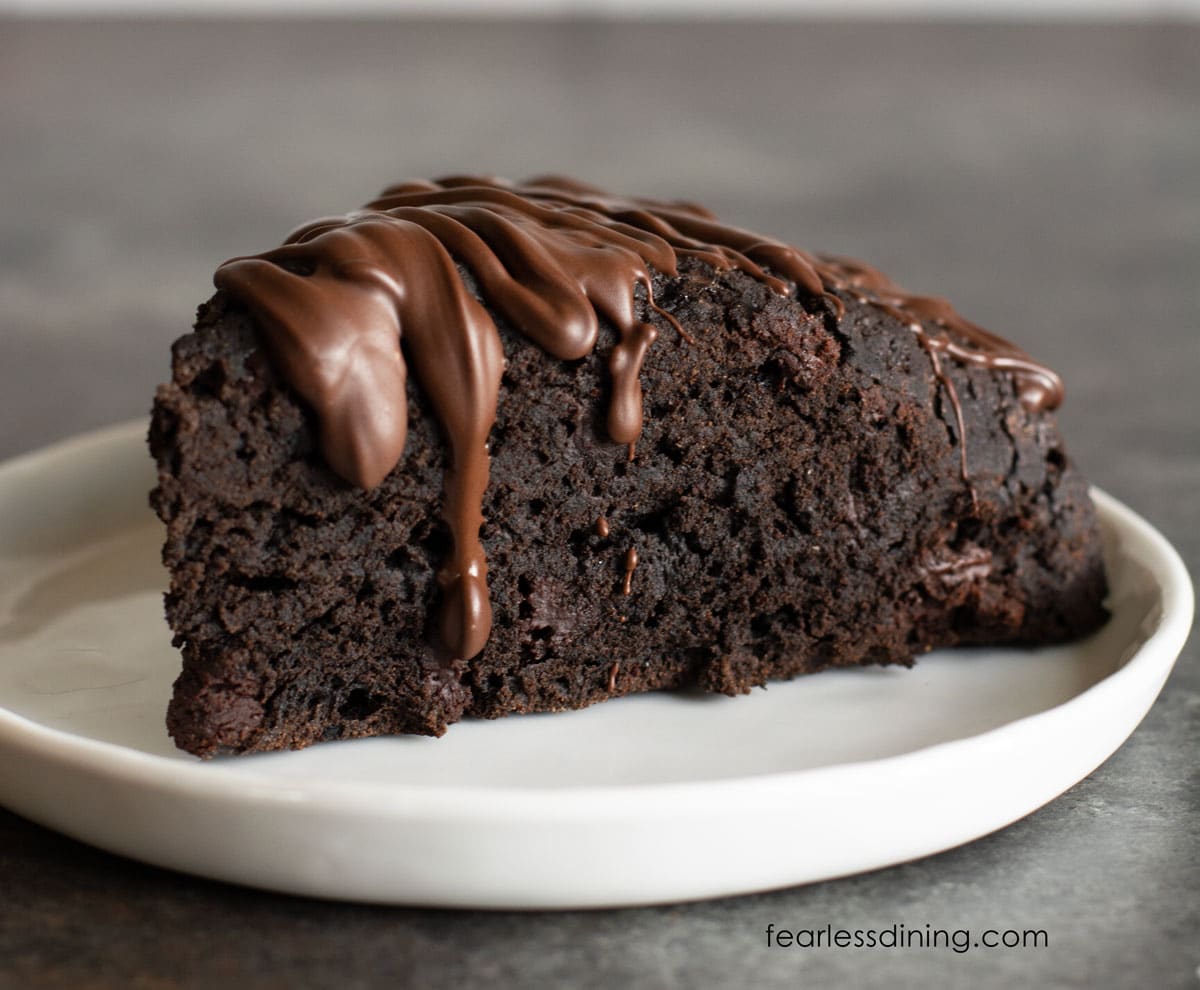 A view of a chocolate scone with chocolate drizzled over the top.