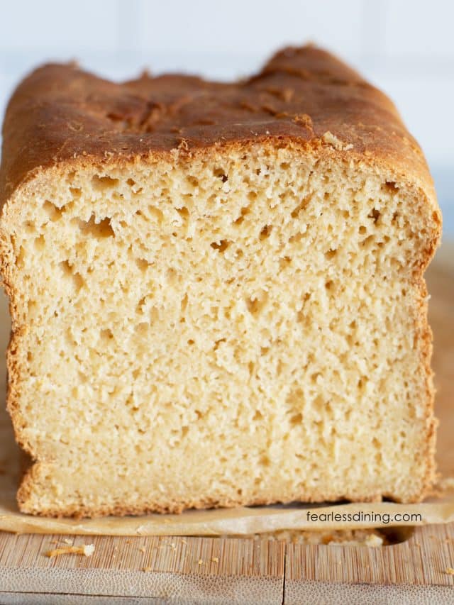 A loaf of gluten free Hawaiian bread with the ends sliced off so you can see the inside crumb.