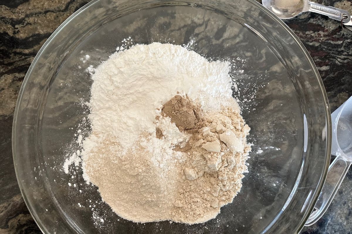 All of the ingredients for the whole grain flour blend in a large mixing bowl.