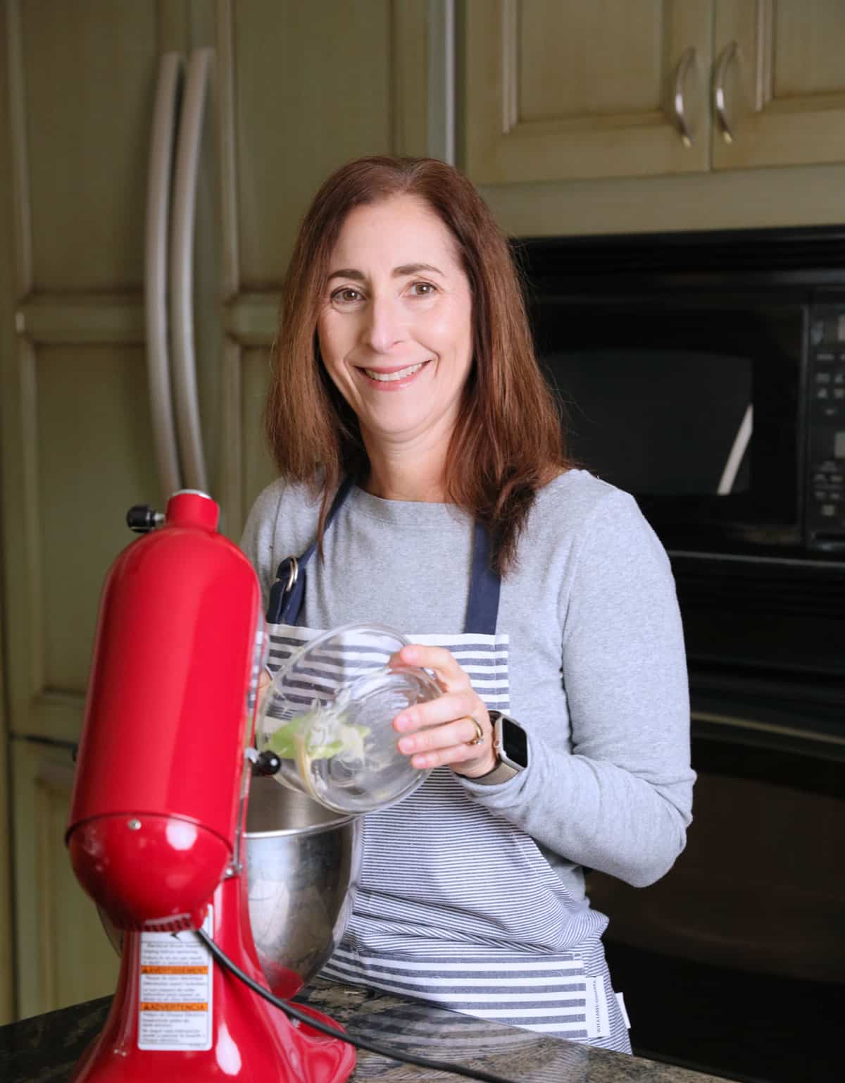 Sandi adding butter to a stand mixer.