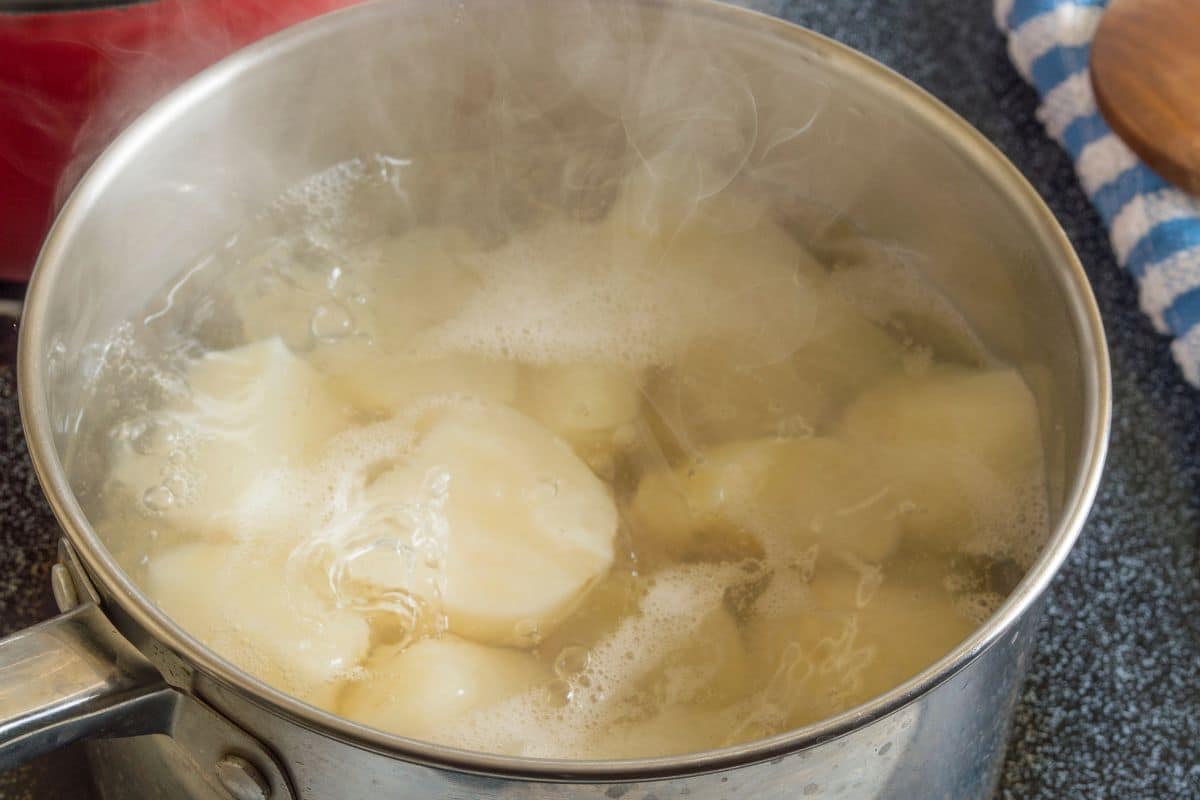 Potatoes boiling in a pot of water.