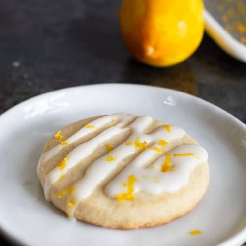 A gluten free lemon shortbread cookie topped with lemonade icing and lemon zest.