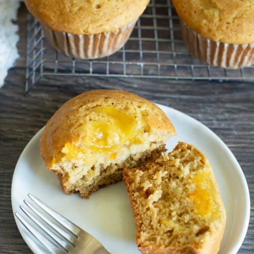 A marmalade muffin cut in half so you can see the marmalade on top.