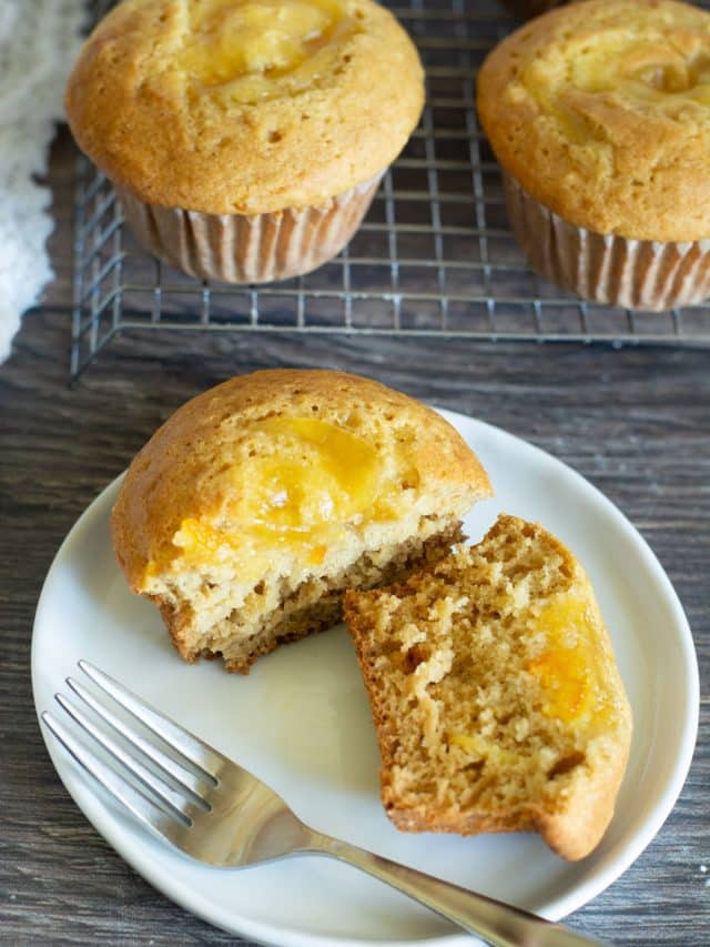 A marmalade muffin cut in half so you can see the marmalade on top.
