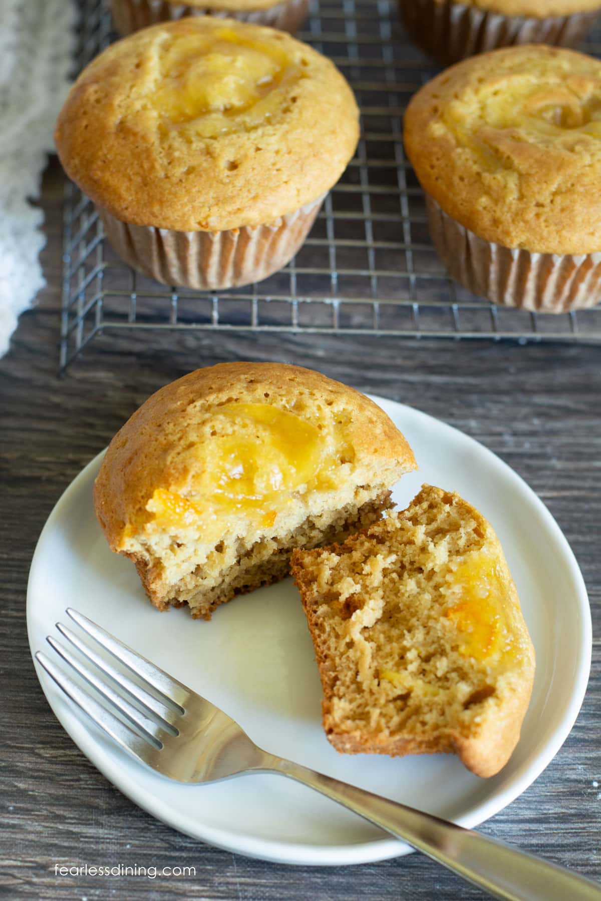 A marmalade muffin cut in half so you can see the marmalade on top.