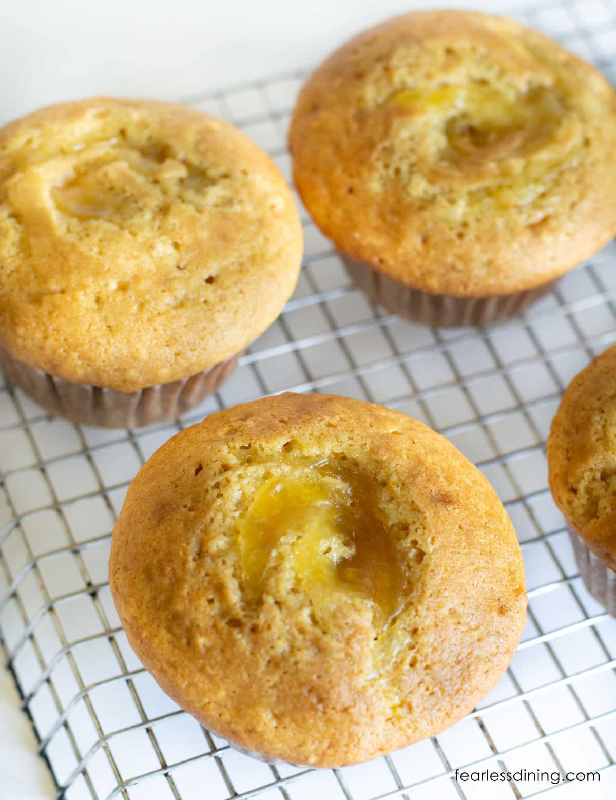 A photo of the gluten free orange marmalade muffins cooling on a wire rack.