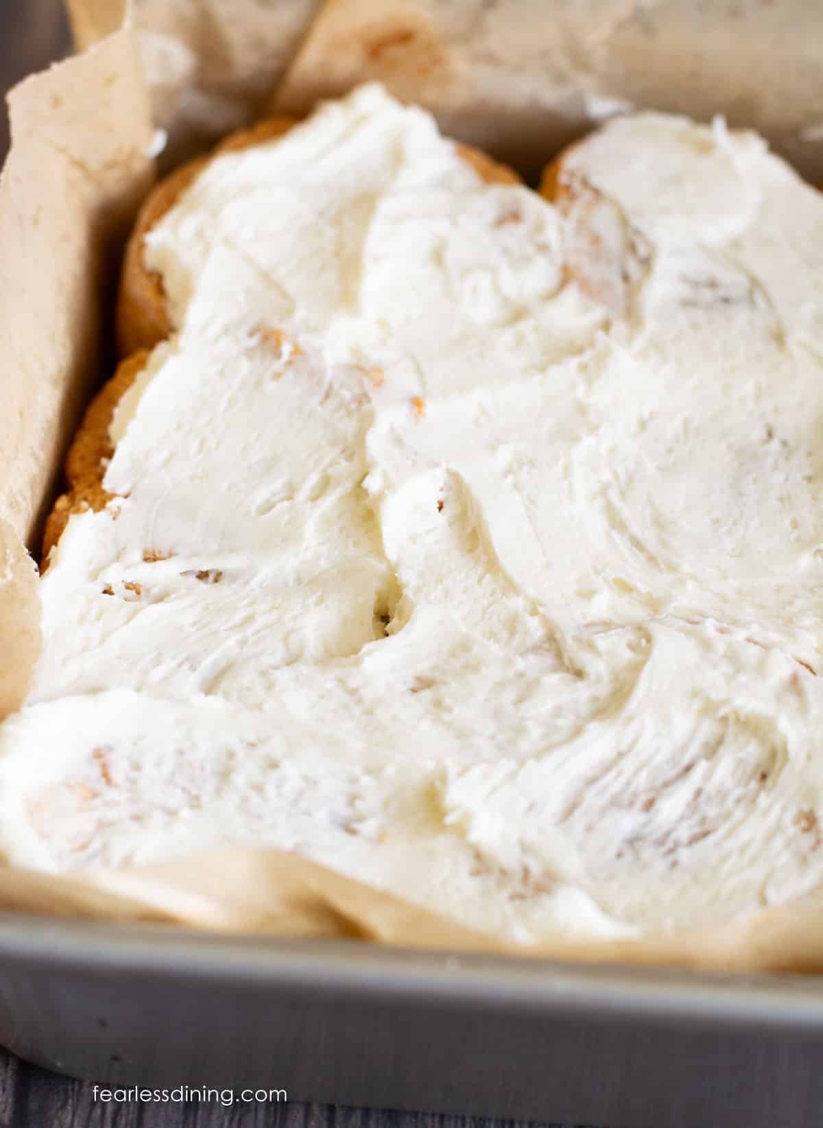 A pan full of frosted no-yeast cinnamon rolls.