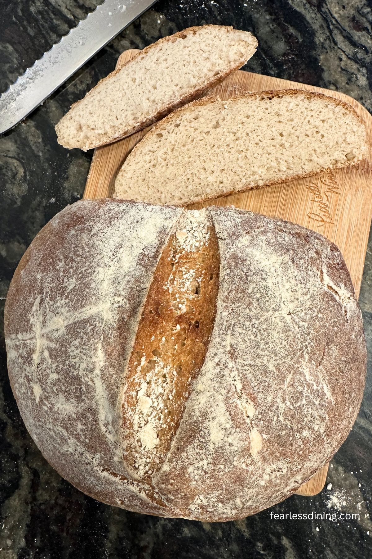 The top view of sliced sourdough on a wooden cutting board.