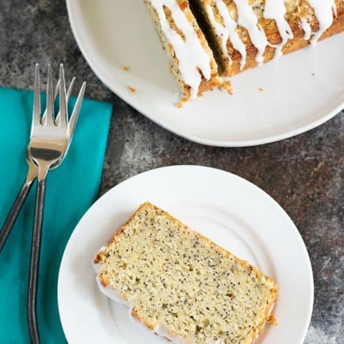 The top view of the sliced cake and a slice of gluten-free lemon poppy seed cake on a plate.