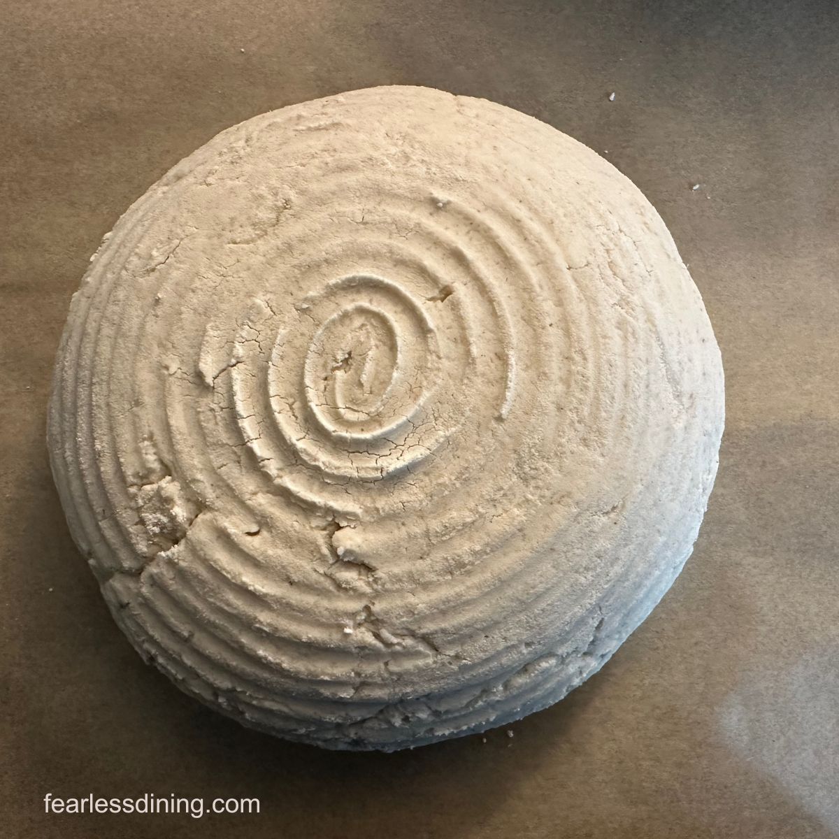 A boule of dough with the swirl markings from the banneton.