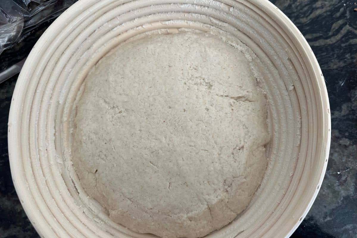 Dough in a flour dusted banneton basket.
