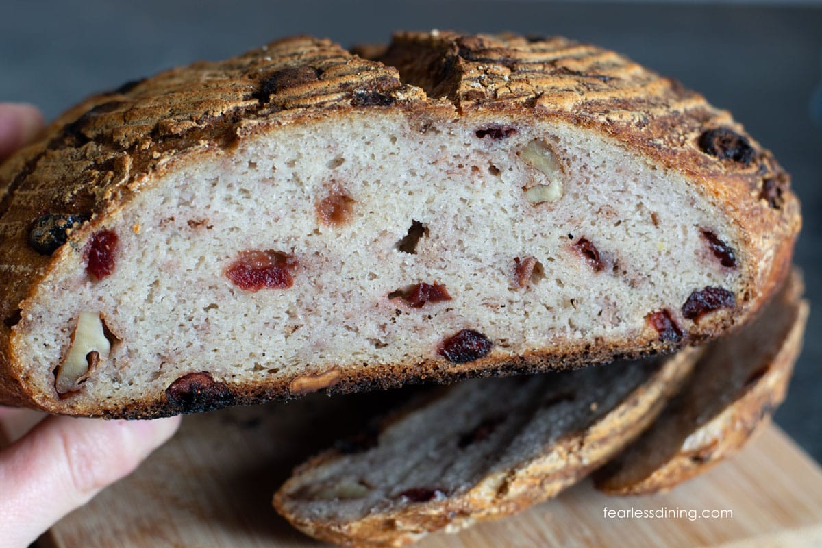 The cranberry sourdough loaf cut in half so you can see the inside.