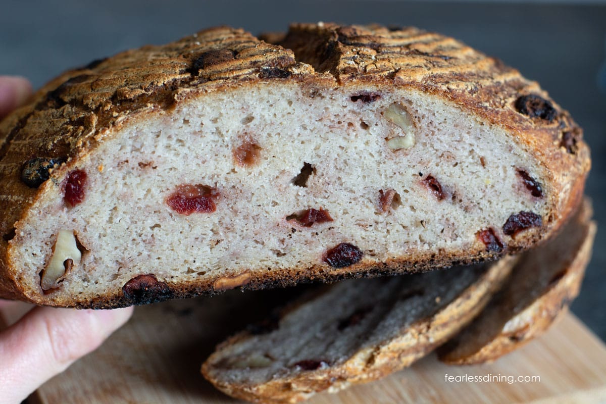 The cranberry sourdough loaf cut in half so you can see the inside.