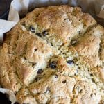 A Pinterest pin image of the Irish soda bread in a cast iron skillet.