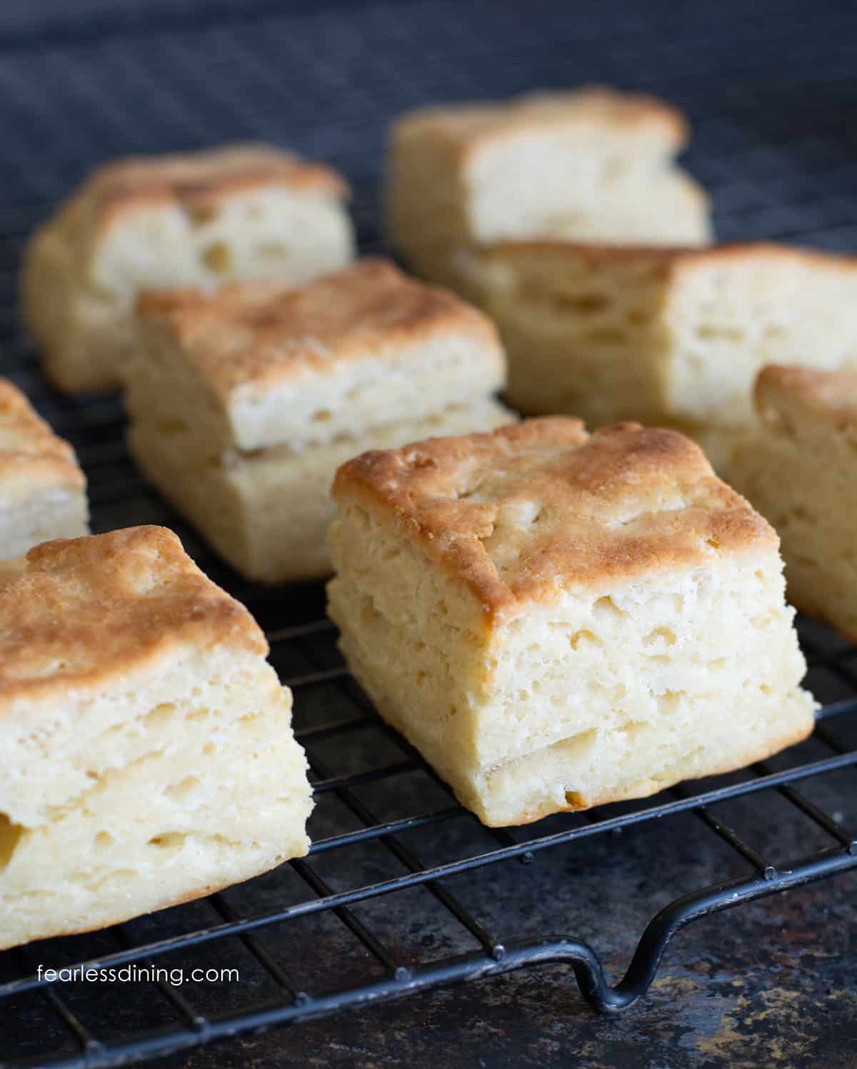 Biscuits fresh out of the oven and cooling on a wire rack.
