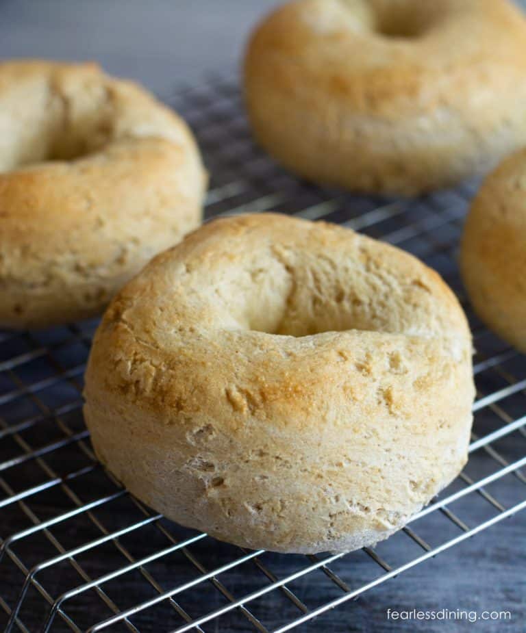 Baked gluten free yeast free bagels on a cooling rack.