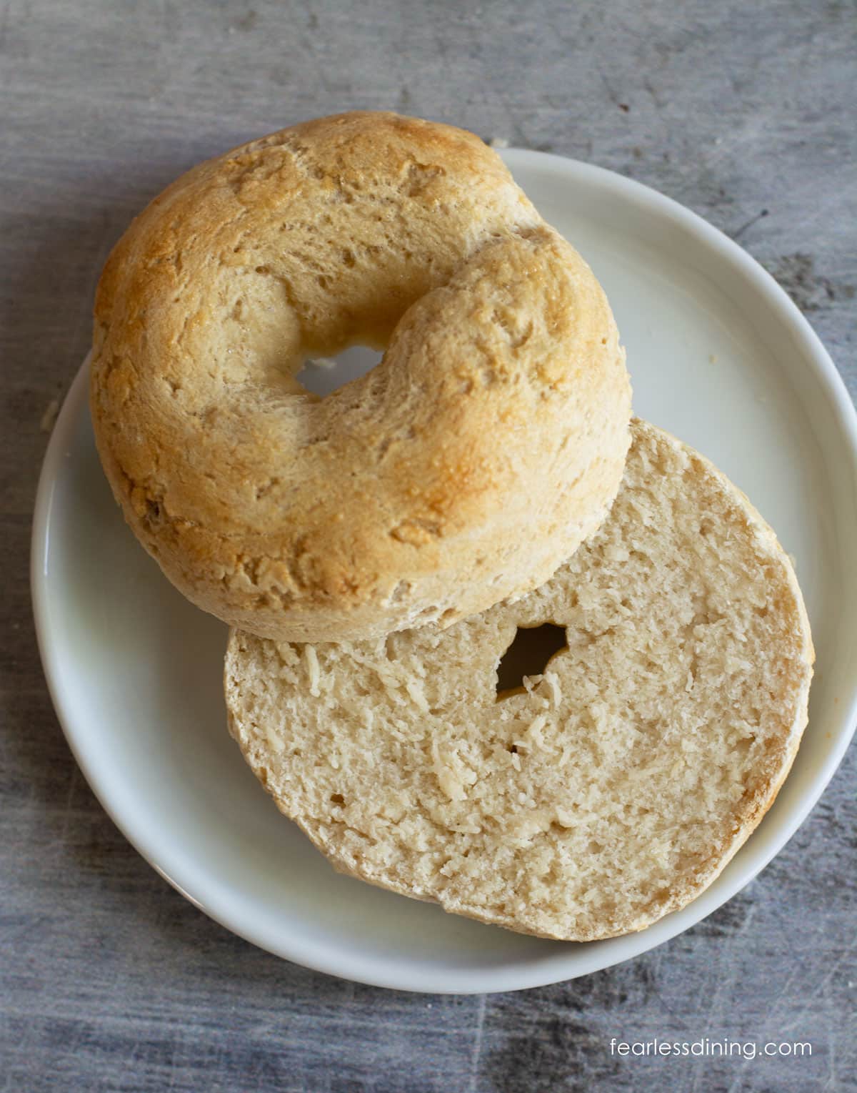 A bagel sliced open so you can see the inside.