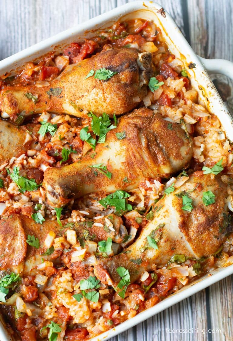 An 8x8 casserole dish filled with baked Mexican Chicken and Rice.