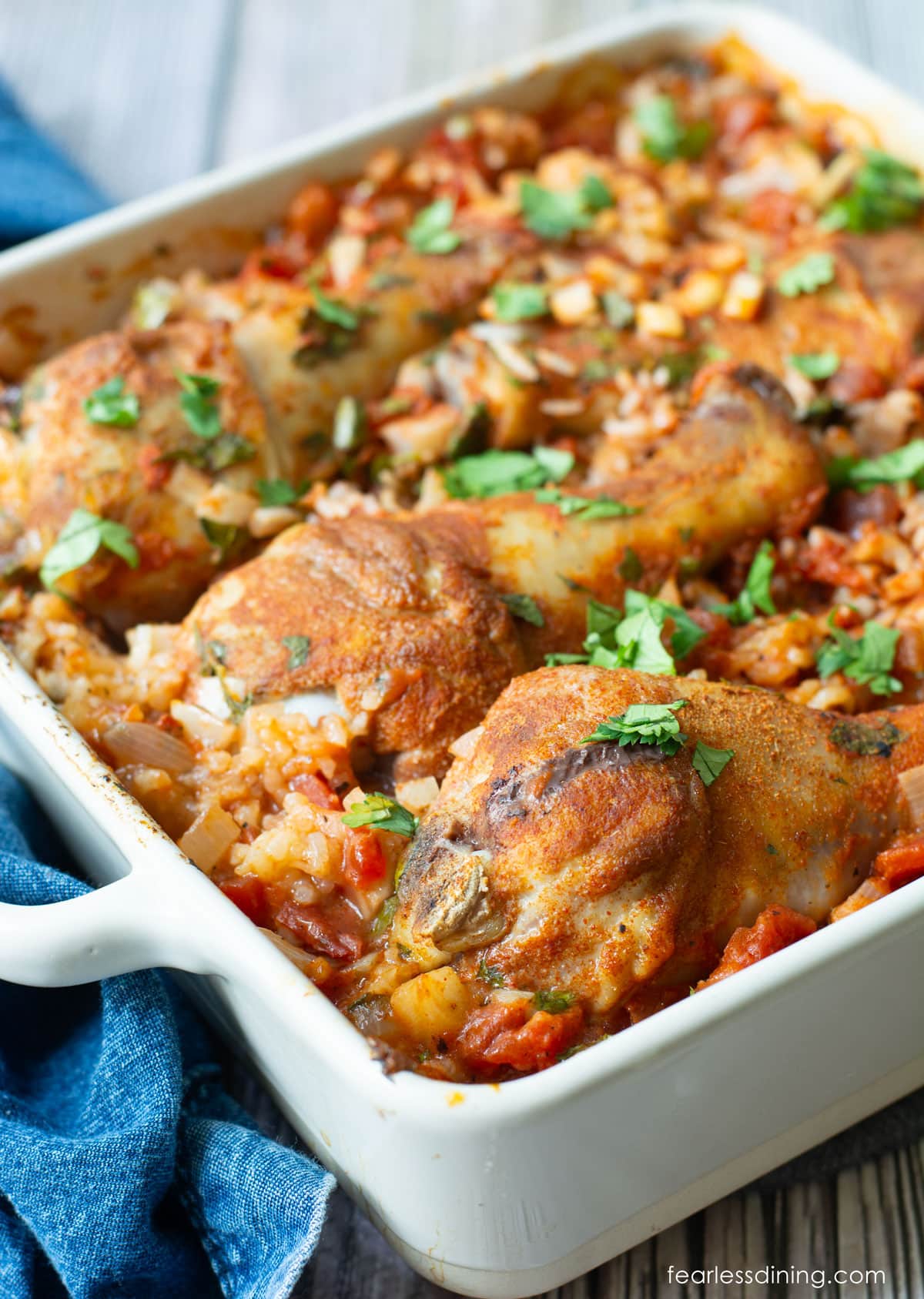 A casserole dish filled with baked chicken and rice.
