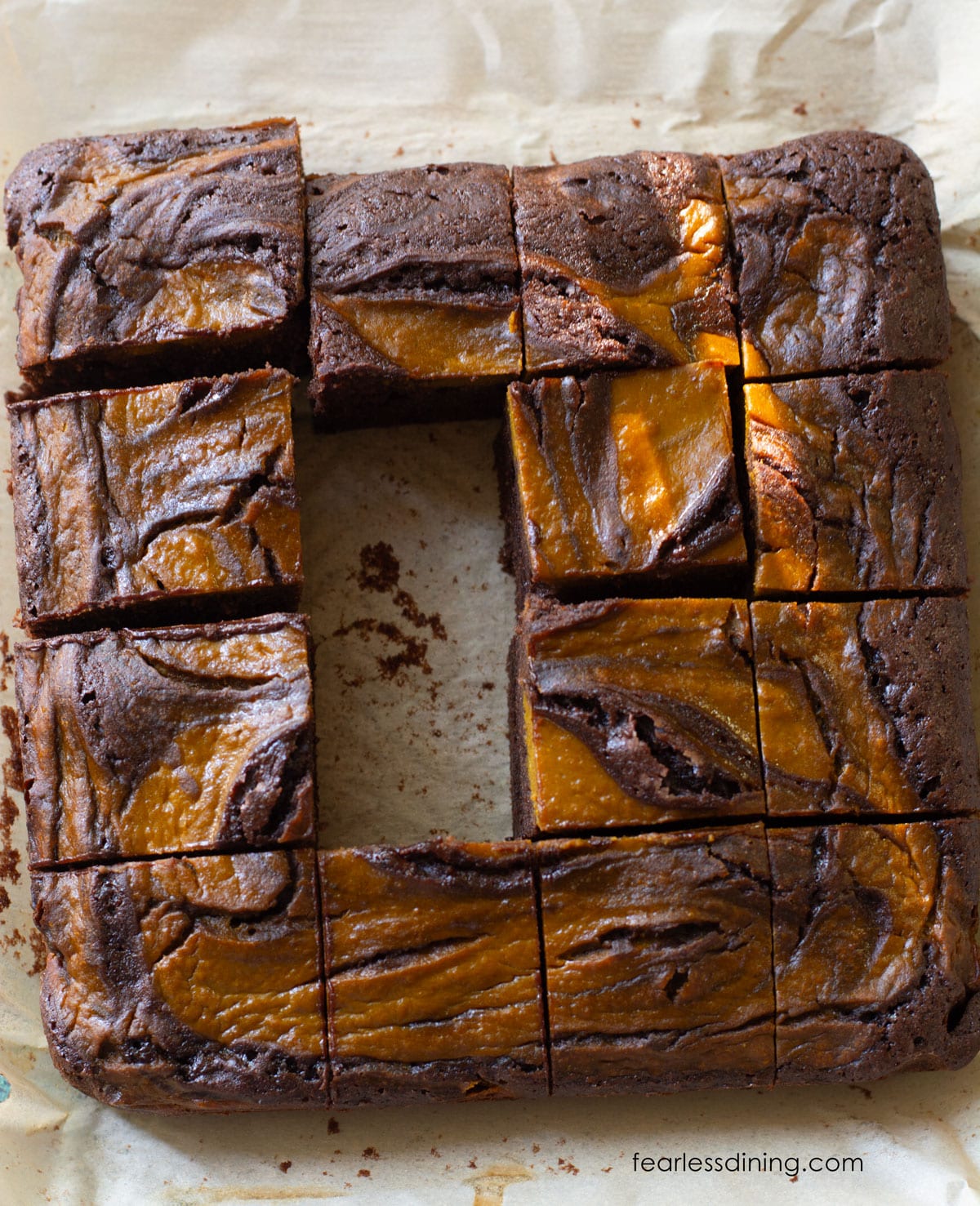 The baked brownies with two pieces in the middle missing.