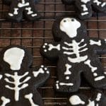 Decorated skeleton cookies on a cooling rack.