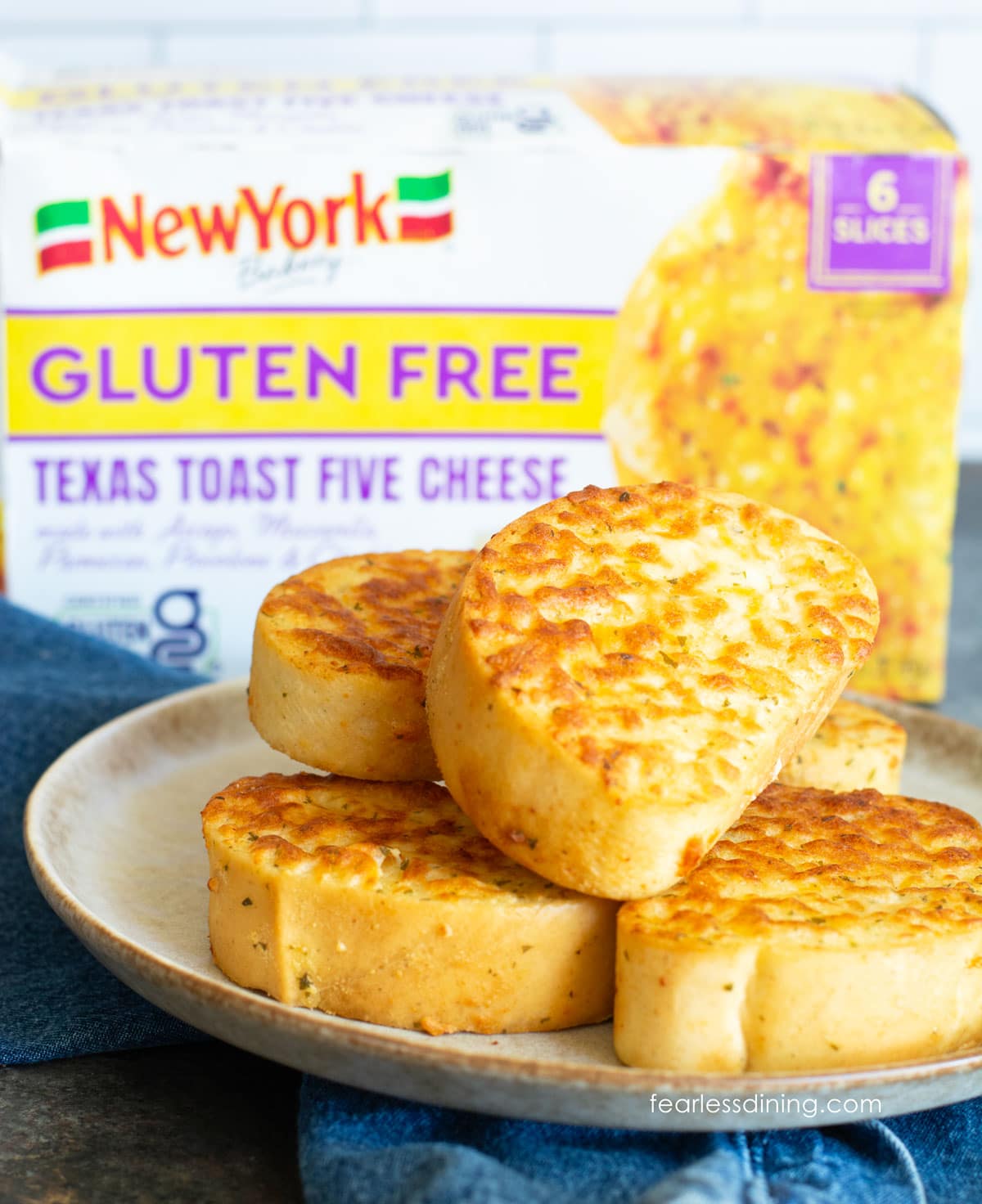 Toasted Five Cheese Texas Toast slices on a plate next to the box.