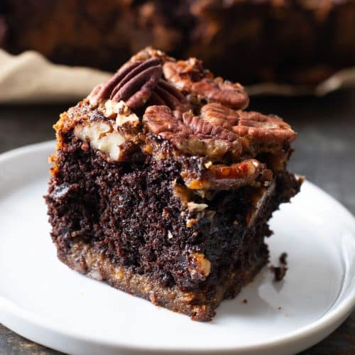 A gluten free pecan pie brownie slice on a plate.