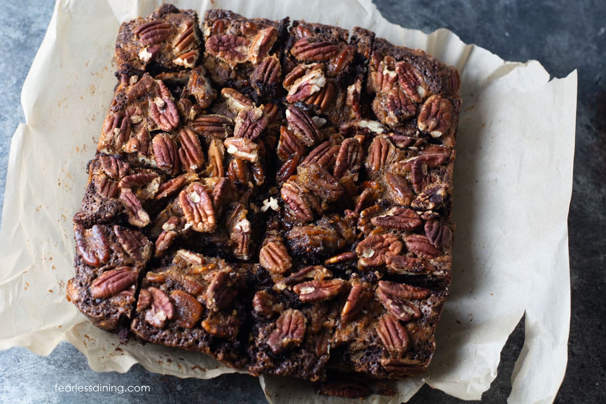 The cut brownies on parchment paper.